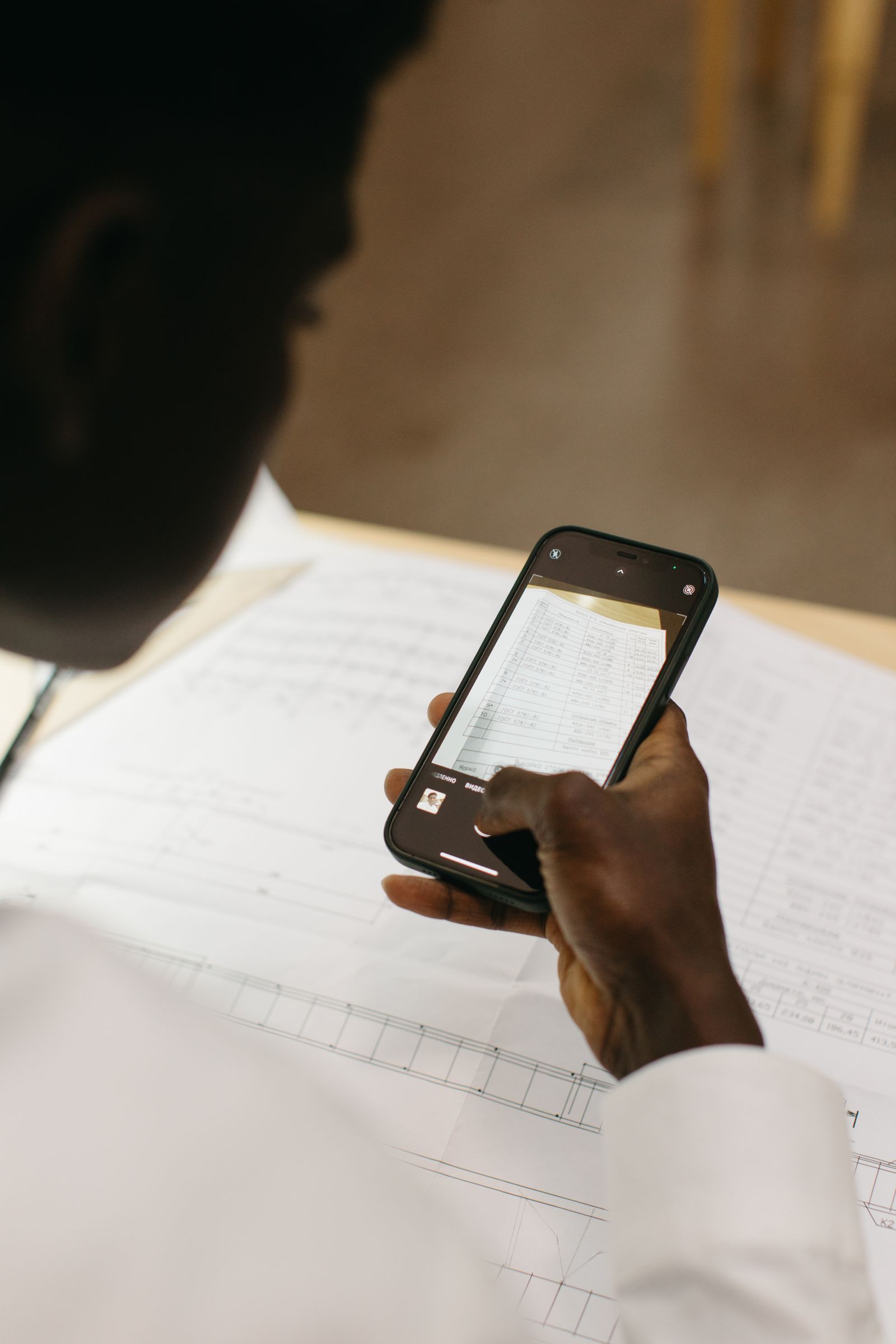 A person using a smartphone camera to scan a paper document